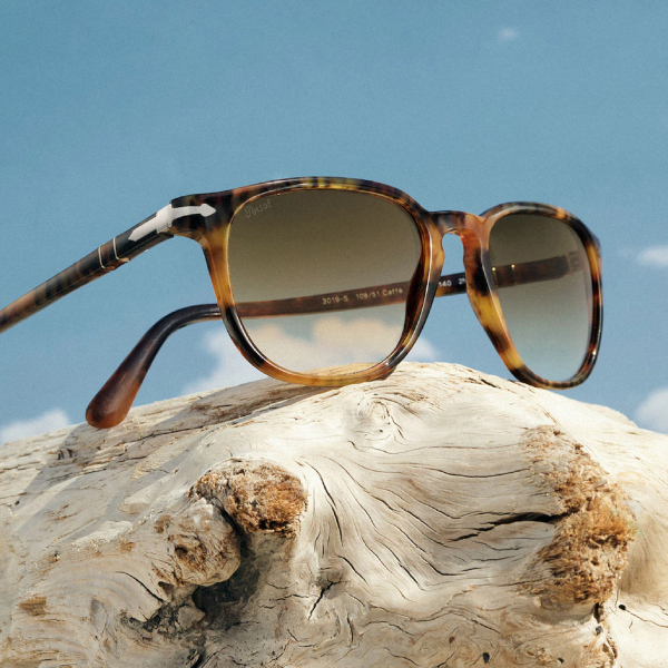 Persol mens sunglasses on a rock with the sky above