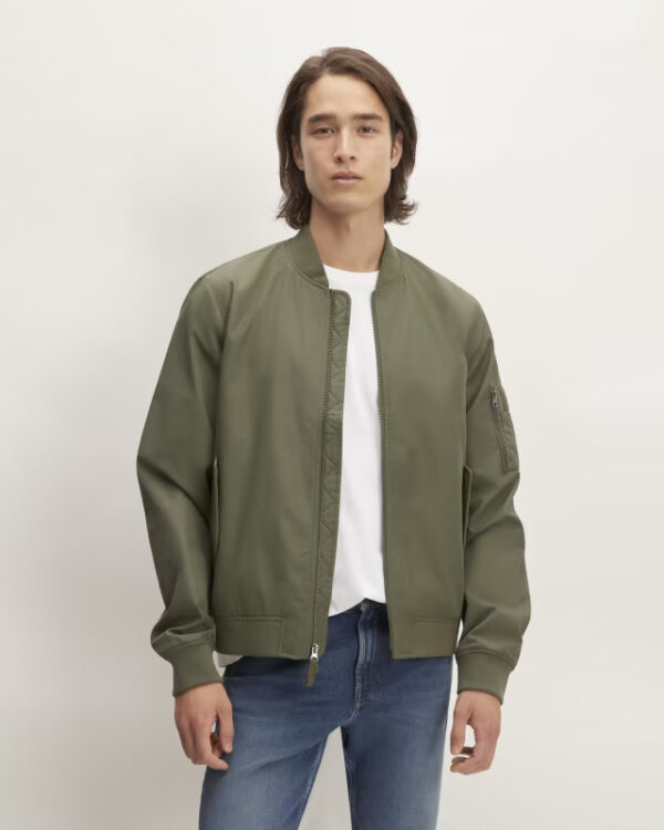 Kalamata olive colored bomber jacket with two-way zipper and magnetic closure pockets.